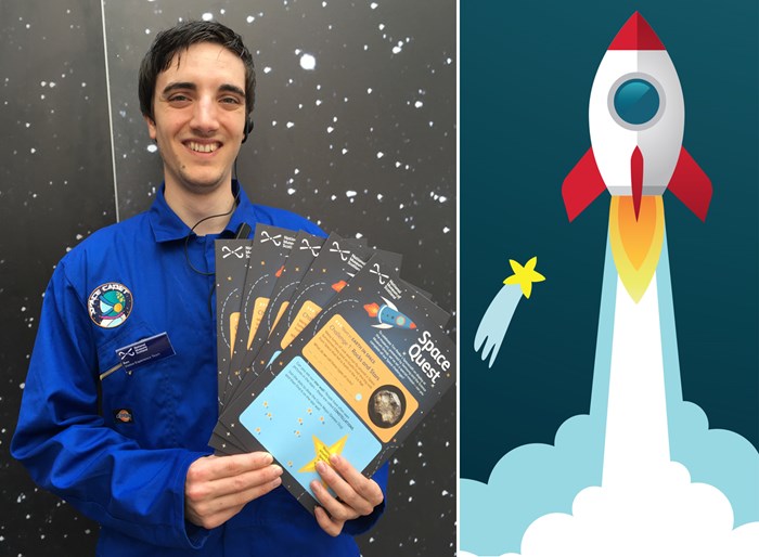 Museum employee holding space quest trail flyers.