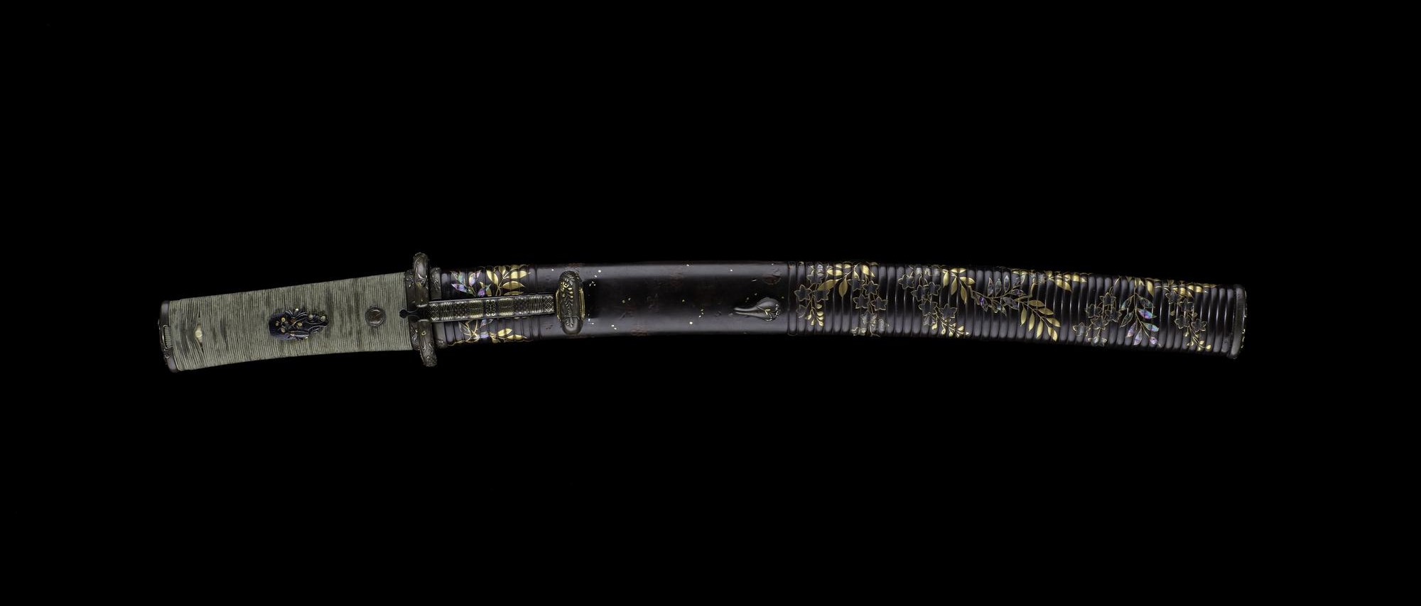Sword with a curved single-edged steel blade signed in brass inlay, a wooden hilt wrapped in silk cord, and signed shibuichi mounts: Japan, blade by Kunihiro, mounts by Issho.