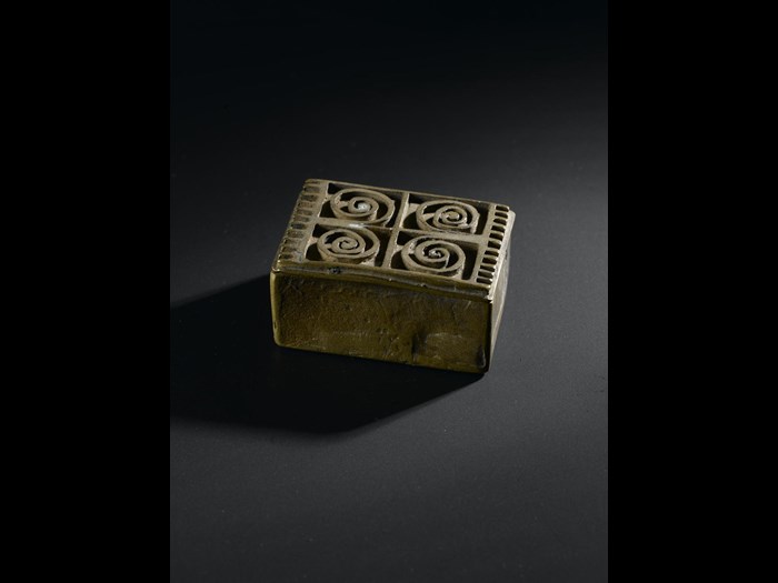 Brass box for holding gold-dust, rectangular with lid decorated with relief scrolls, produced by lost-wax casting: West Africa, Ghana, Asante, late 19th to early 20th century