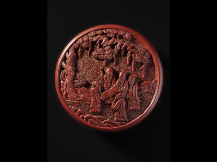 Circular covered box of red lacquered wood, with five Daoist sages studying a handscroll: China, Qing dynasty, 18th century.