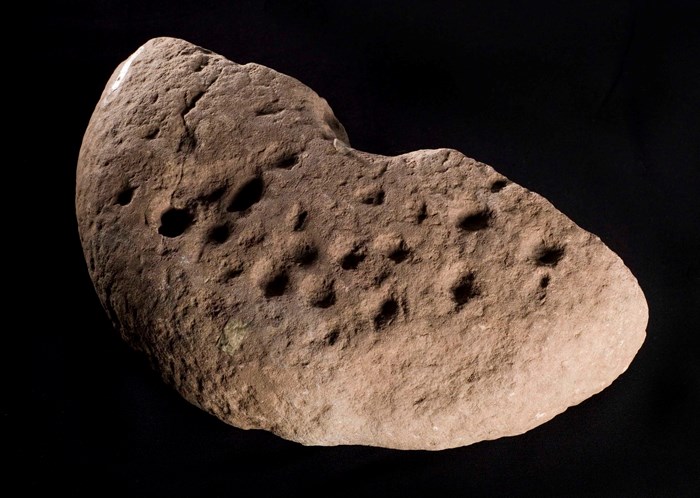 An Iron Age decorated rotary quern fragment from Broxmouth, East Lothian.