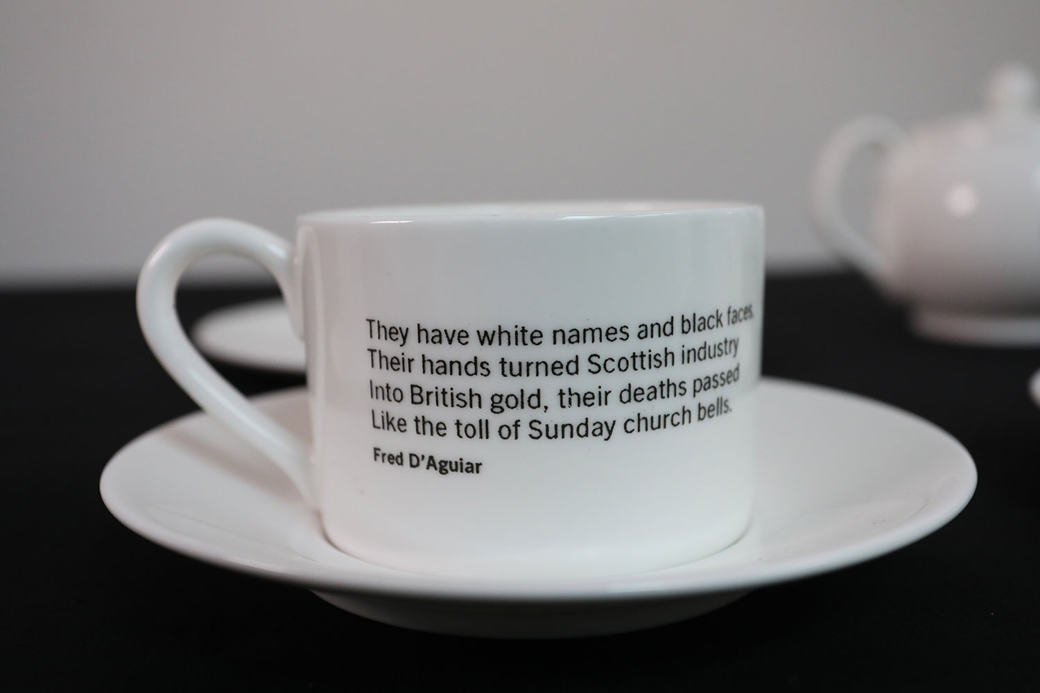 Porcelain teacup with poetry extract, from The Empire Café. At the pop up café in Glasgow, during the Commonwealth Games in 2014, visitors discussed new understandings of Scotland’s slavery past over the products of empire. National Museums Scotland, X.2017.89.4.