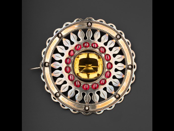 Silver plaid brooch set with a cairngorm in the centre and a ring of sixteen carbuncles round it, worn by the chiefs of Clanranald, mid-19th century.