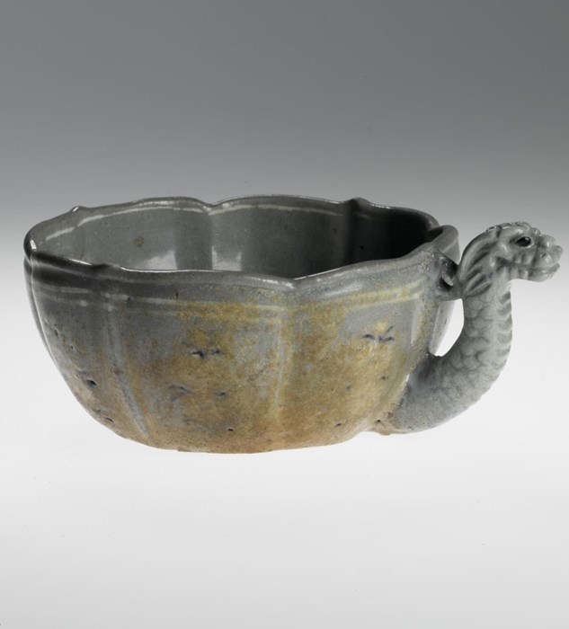Fluted cup of stoneware with one moulded dragon handle, decorated on the interior and sides with slip inlay (sanggam) of floral motifs in white and black: Korea, 12th century.