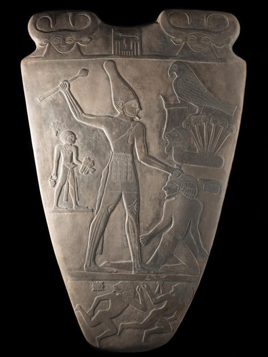 This is a cast of one of the most important objects excavated in Egypt. The original is made of siltstone and is decorated on both sides. The largest figure represents one of the first kings of a united Egypt, King Narmer. He is shown about to attack an enemy with a mace. The original was excavated at Hierakonpolis in 1895.