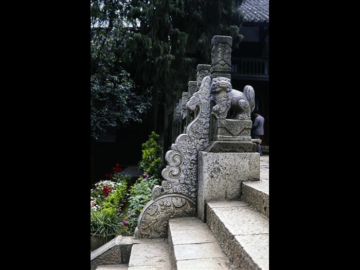 Steps up to the main entrance of Huating Temple with a stone lion sculpture, Kunming, Yunnan Province, China, 1988.