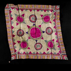 Pale coloured barkcloth painted with a brightly coloured pattern