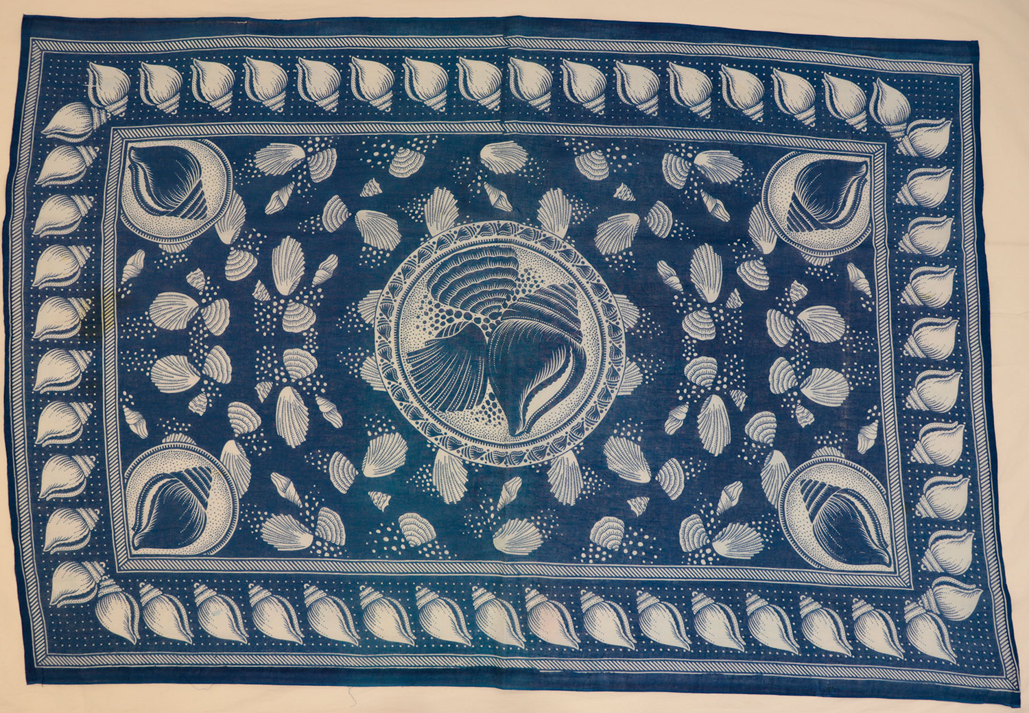 Capulana featuring a pattern of different white sea shells with a rectangular border of a shells: Africa, Southern Africa, Mozambique, 1994-2000.