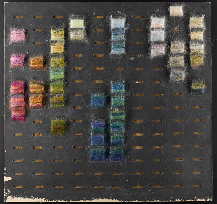 This colour board (1960–80) was designed and used by Bernat Klein in his textile design business. Made of hard board with a black cardboard front, it has 140 oval holes for balancing colours in the design of woven textiles.