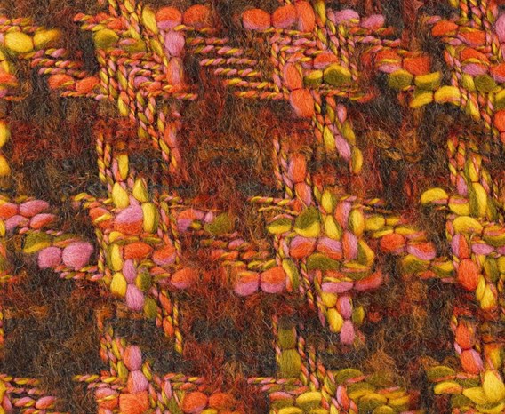 Close-up detail of wool and mohair woven tweed fabric in green, yellow, orange, and pink.