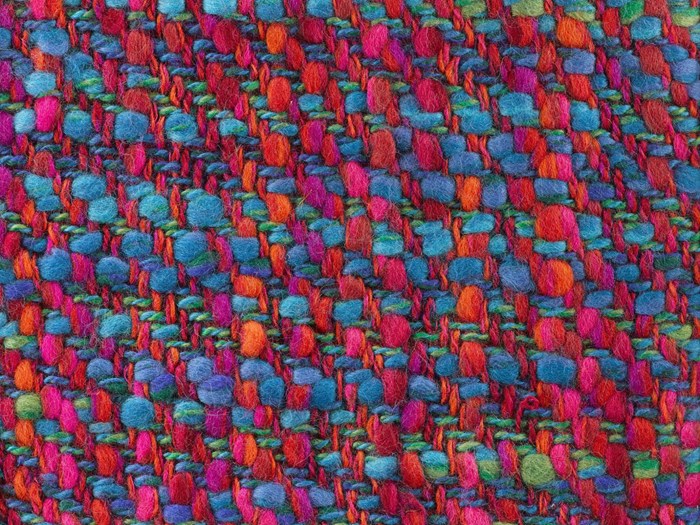 Sample of tweed entitled Aurora, woven in multiply wool slub and multiply wool and polyester and wool yarns, in light and dark blue, orange, red, pink, purple and green.