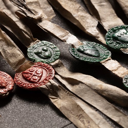 Red and green wax seals fixed to paper tassels attached to the Declaration of Arbroath.