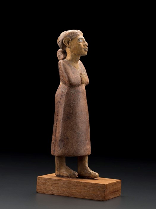 Wooden statuette of a woman from Western Asia carrying a child on her back