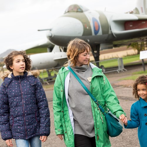 Visitors outdoors in front of the Vulcan airplane