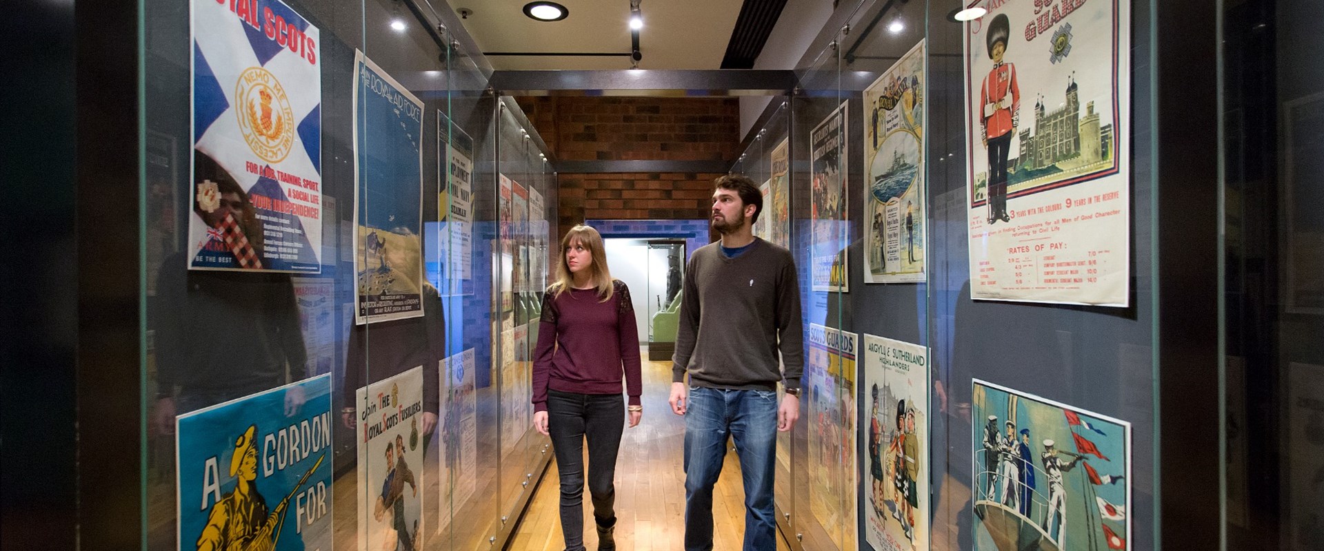 Two visitors walking through a gallery at the National War Museum.