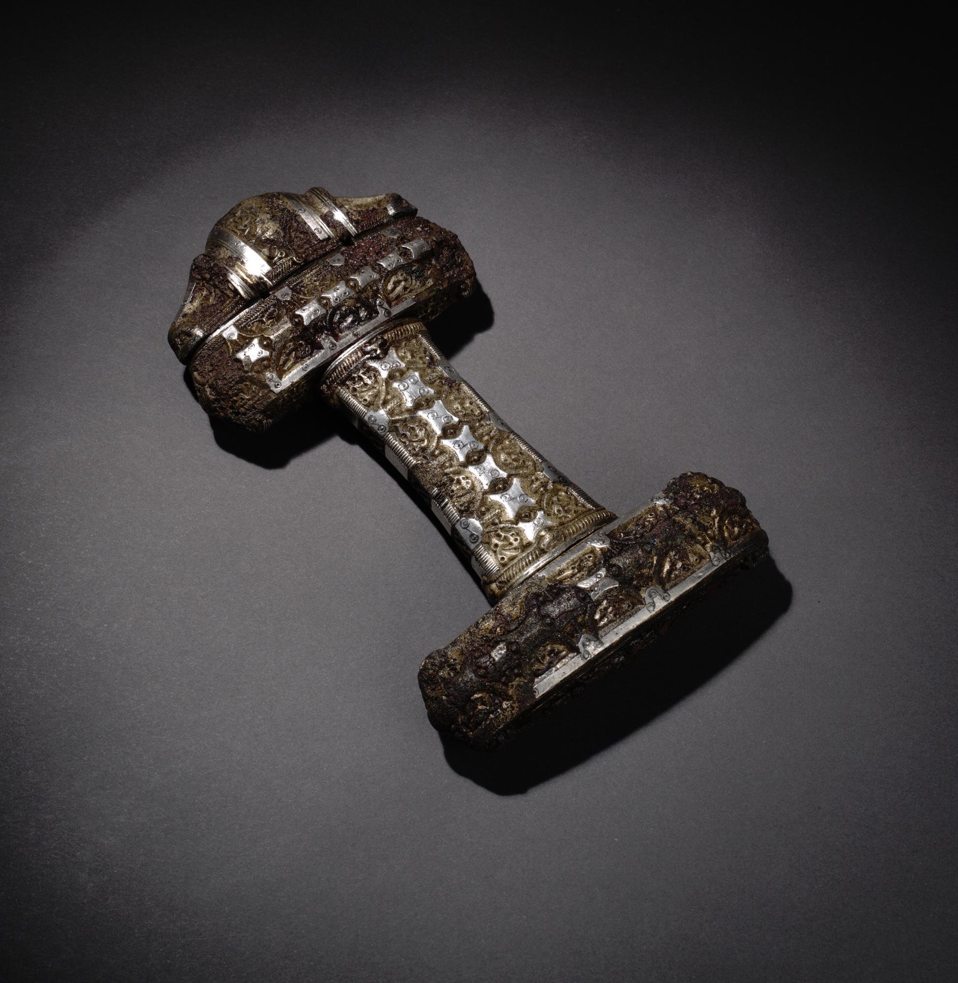 Viking sword hilt of bronze inlaid with silver, from Eigg, 9th century