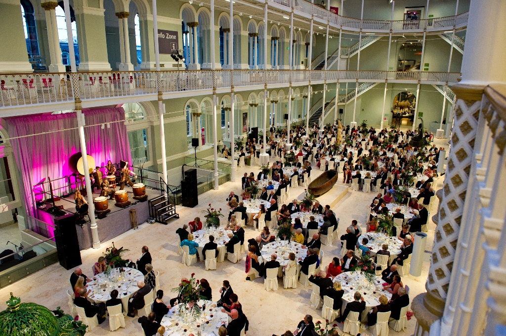 An aerial view of the Grand Gallery at the National Museum of Scotland set up for a large dinner event.