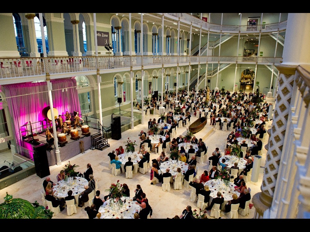 An aerial view of the Grand Gallery at the National Museum of Scotland set up for a large dinner event.