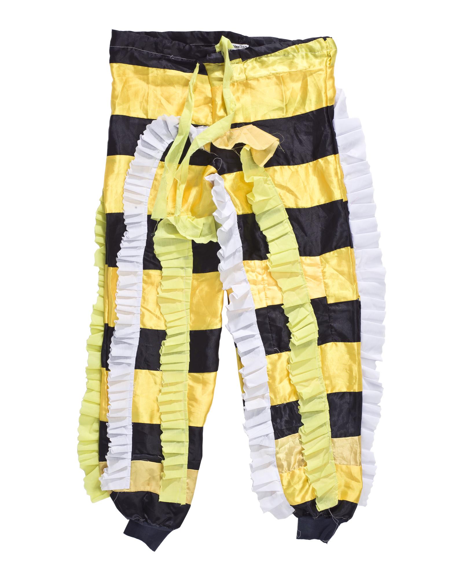 Drawstring trousers made to be worn as part of 'Fine Lady' fancy dress masquerade costume, made of yellow and black man-made fabric with yellow and white frills, originally purchased by Donatus Archibald Acquandoh (alias Hippies) from a tailor in Winneba: Africa, West Africa, Ghana, Winneba, 2000 