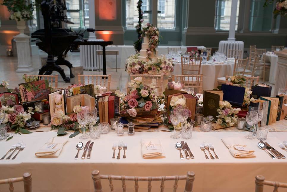 A banquet-style table set up for a wedding in the National Museum of Scotland's Grand Gallery.
