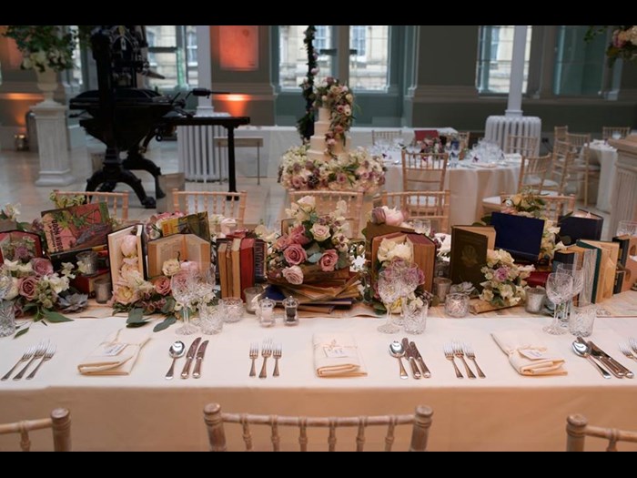 Banquet-style table set up for a wedding in the National Museum of Scotland's Grand Gallery.