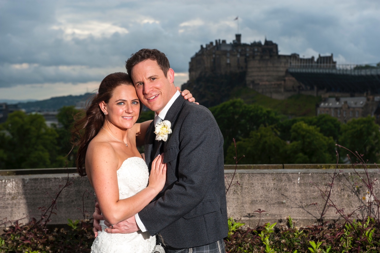 Newlyweds on the National Museum of Scotland's Roof Terrace with a view of Edinburgh Castle in the background.