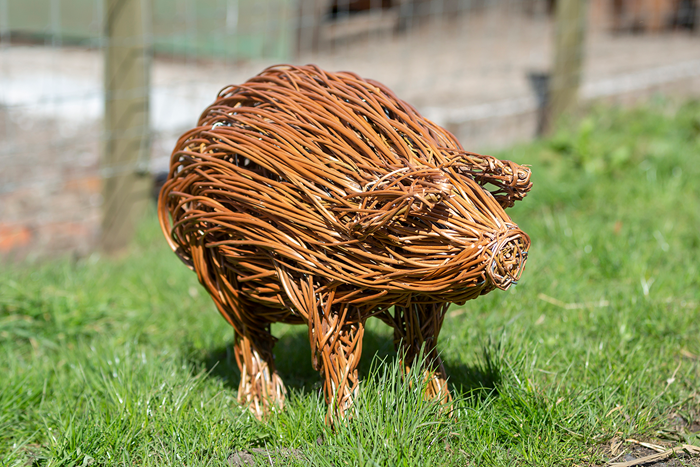 A pig sculpture made of willow.