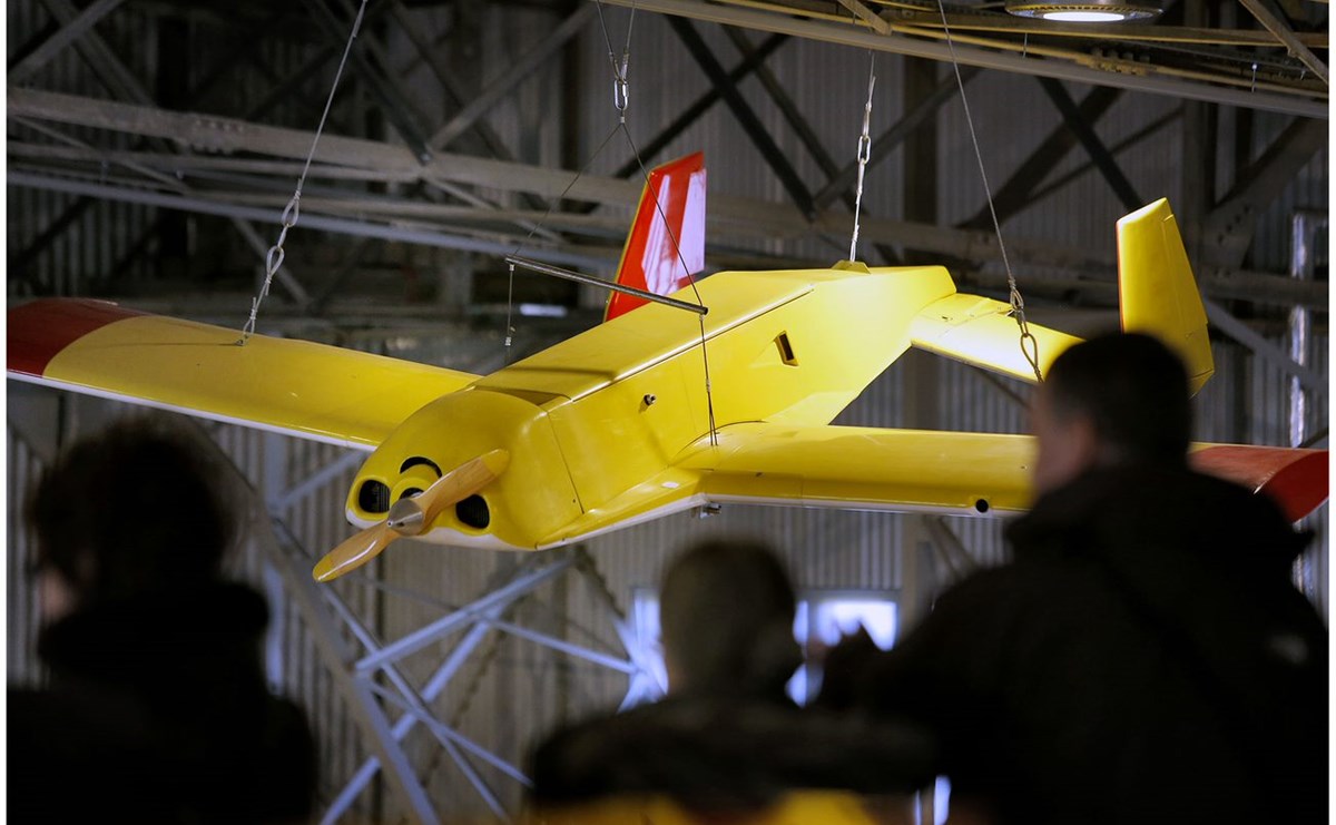 Yellow aircraft suspended from the ceiling of a hangar at the National Museum of Flight.