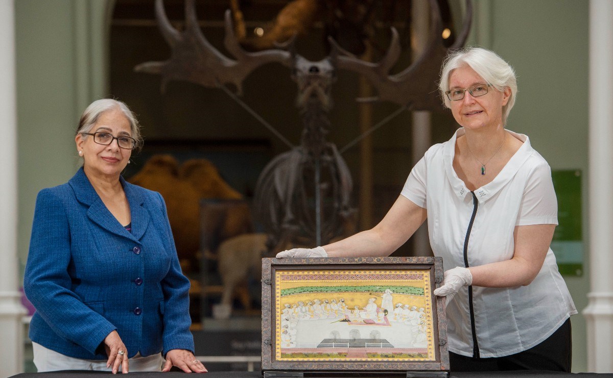 Friederike Voigt and Naina Minhas with a painting from the Archibald Swinton Collection June 2021