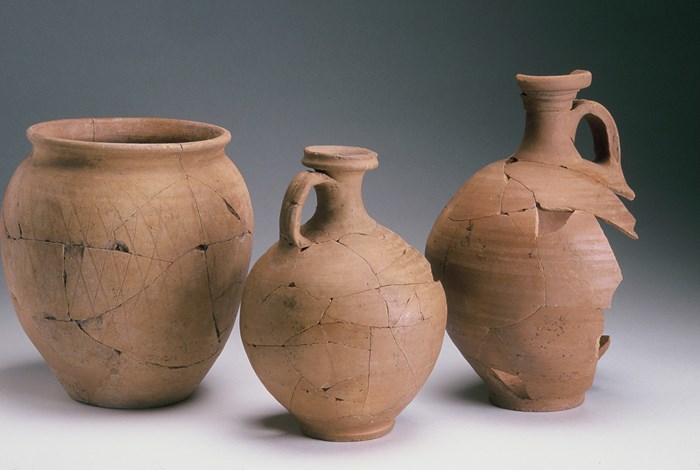 Three pots, each of varying size and shape, of beige colour side by side