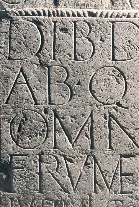 Close-up of Latin script on a light grey stone slab
