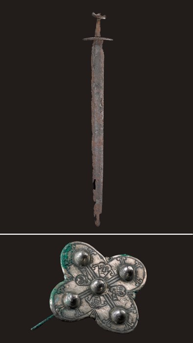 Two images stitched together. On top is a rusted Viking sword, and separated by a white line is a quatrefoil brooch with four faces around a central nub.