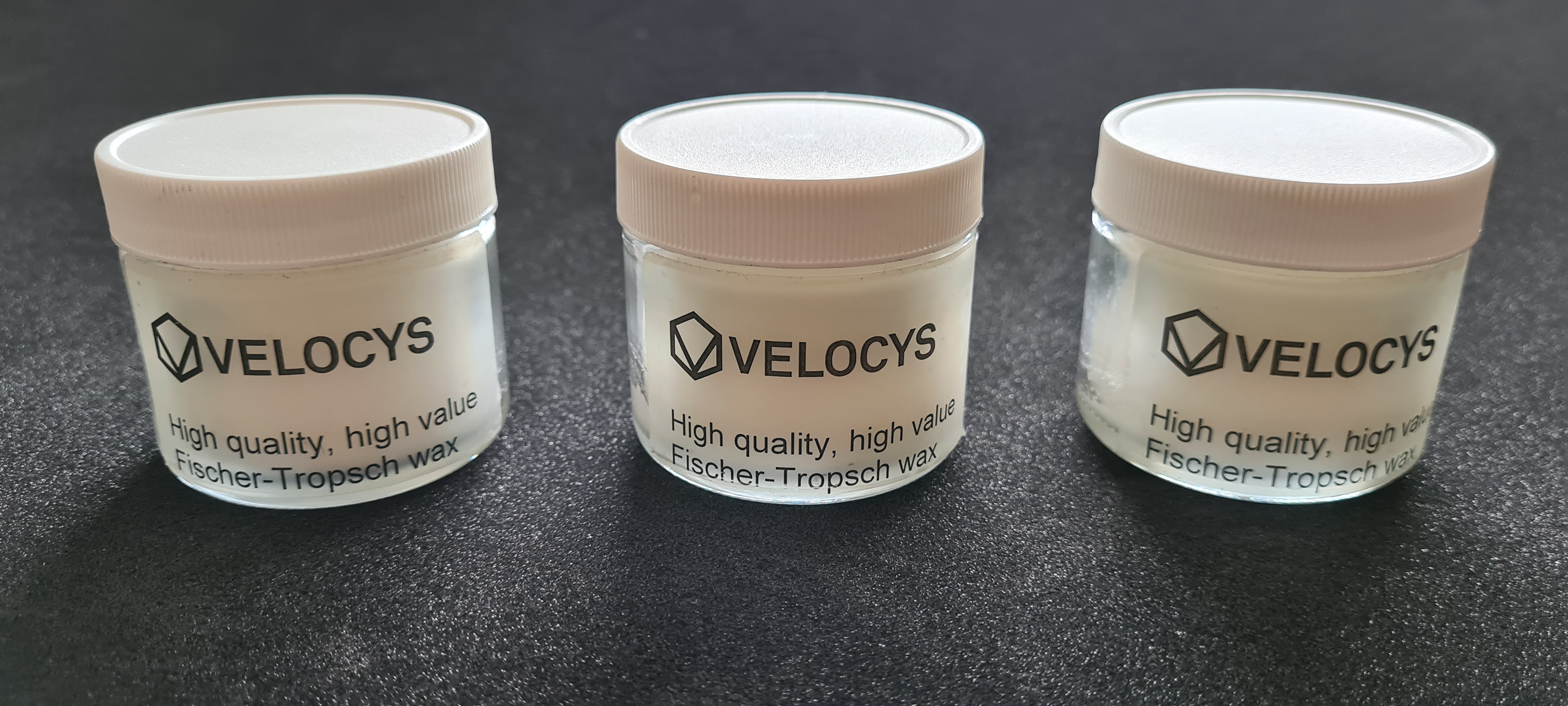 Parafin wax, EF.2020.4.1-3. These are three jars of paraffin wax, produced by Velocys using the Fischer-Tropsch process. This turns domestic waste into paraffin wax which can then be turned into jet fuel. It burns more cleanly than normal kerosene, in particular avoiding the sooty particulates that are normally produced. This is therefore a cleaner burning fuel produced from waste diverted from landfill. It is hoped this can go into full-scale production.