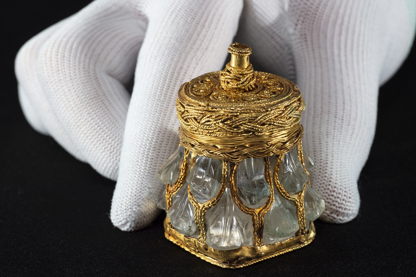 The gold-mounted rock crystal jar with a hand for scale. © Neil Hanna