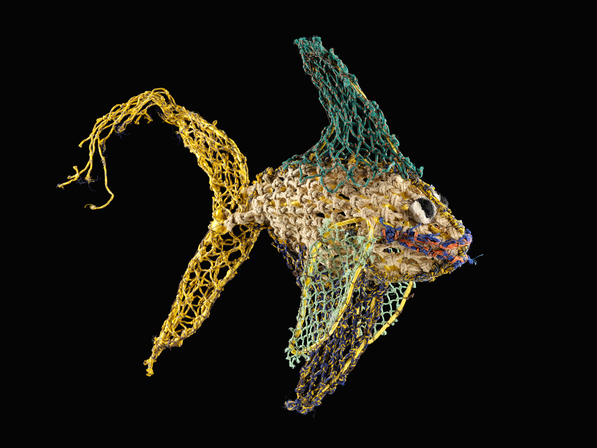 Sculpture of a fish entitled 'Peter Piper' made by Jimmy John Thaiday from plastic fishing nets that have been lost in the ocean around the Torres Strait Islands, Australia, trapping fish and marine animals. The sculptures help to raise awareness of the world-wide problem of ocean pollution. V.2020.17.2 .