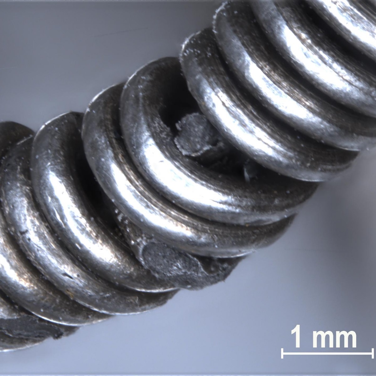 Microscope view of the silver chain, showing how sections of the chain were coiled together.