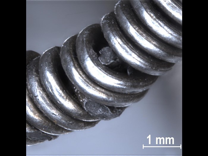 Microscope view of the silver chain, showing how sections of the chain were coiled together.
