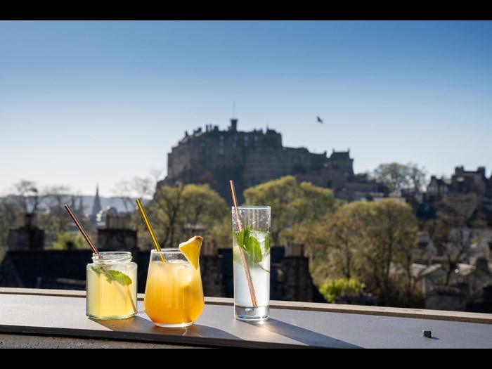 Cocktails and view of Edinburgh Castle from Roof Tops.
