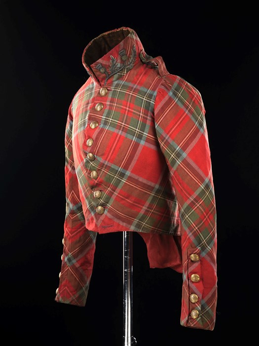 Top half of a bright red tartan suit with green squares, brass-coloured buttons and a popped collar with thistle embroidery.