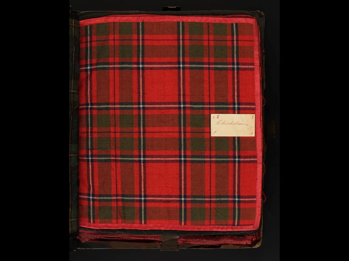 A sample of Chisholm clan tartan, from a bound collection of 58 clan setts dating from the early 19th century. Each sample in the volume is edged with silk and meticulously labelled, suggesting it once belonged to a textile merchant or manufacturer (H.TTB 11)
