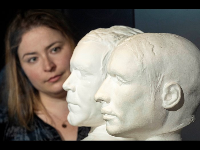 Curator Sophie Goggins with the life masks of mass murderers Burke and Hare. Photo © Neil Hanna