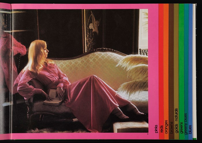 Inside cover of a 1973 Bernat Klein catalogue. A blonde woman in a flowing pink robe luxuriates on a regal cream-coloured couch.