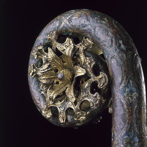 Crosier head with floral cluster in centre of crook and stem decorated with champlevé enamel, from the grave of a bishop. From Roy Ritchie's excavations at Whithorn Priory, Whithorn, Wigtownshire: English, late 12th century (H.1992.1833)