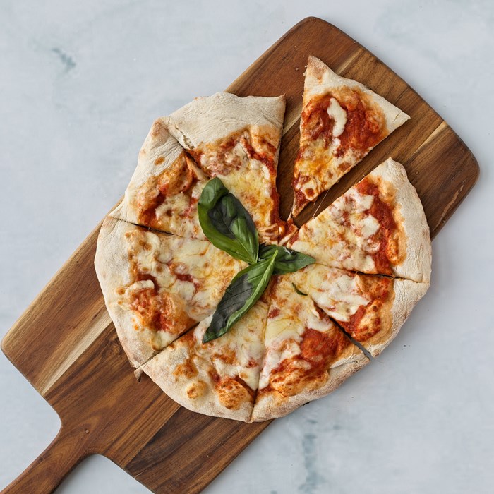 Pizza cut into slices on a wooden board
