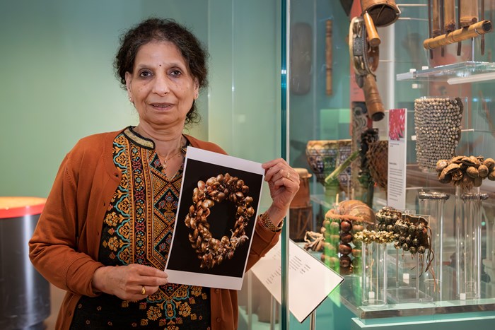Neena holding up a printed picture of the ghungroo ankle bracelet in the Performance and Lives gallery.
