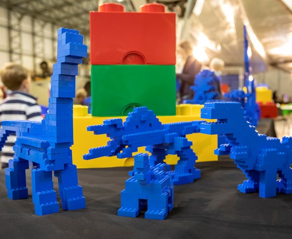 A group of blue dinosaur toys made from LEGO bricks.