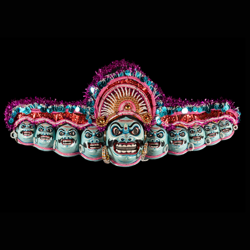 Ten headed papier-mache mask of the demon king Ravana, part of a Chhou dance costume, painted in blues, red, white and black and decorated with beads, sequins and tinsel: India, Bengal, Purulia District, by Nepal Chandra Sutradhar.