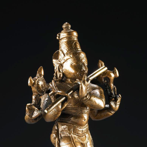 Bronze figure of Krishna, standing playing the flute.