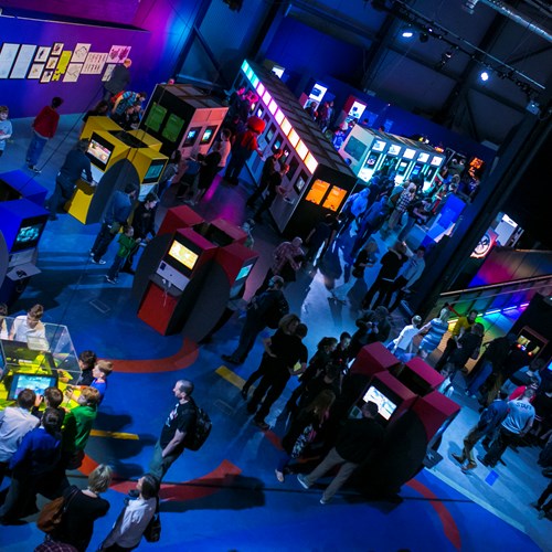 Visitors play with games and consoles across Game On within the exhibition space at Life in Newcastle.
