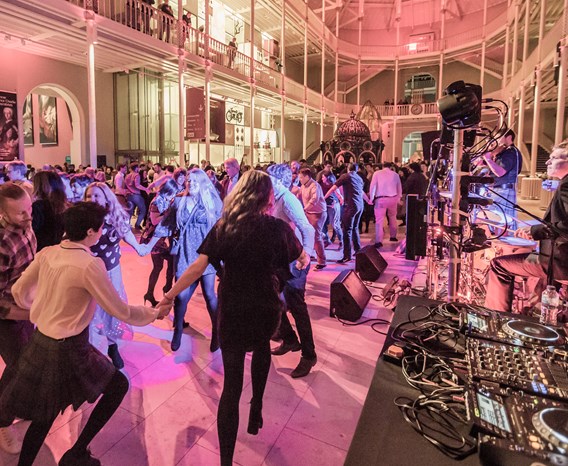 The floor of the grand gallery full of people enjoying a ceilidh.